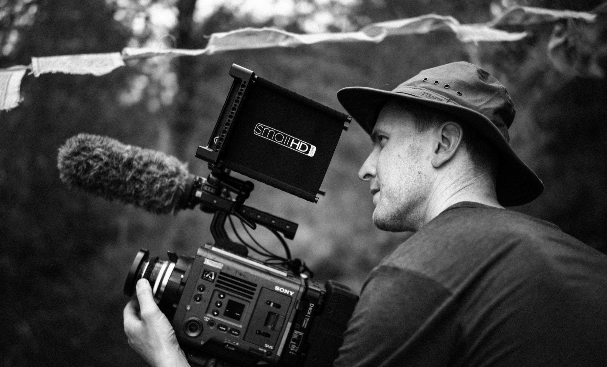 Ryan filming outdoors with a cinema camera