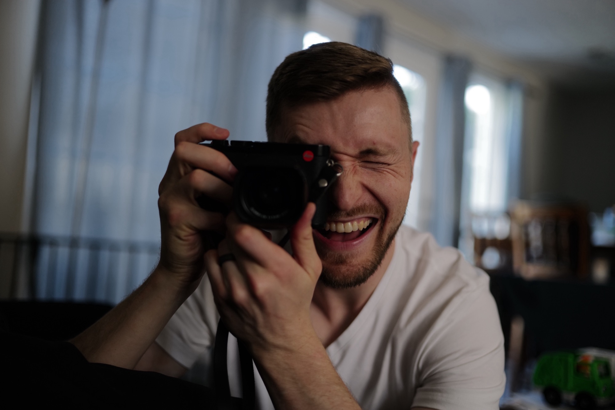 Ryan laughing behind a camera